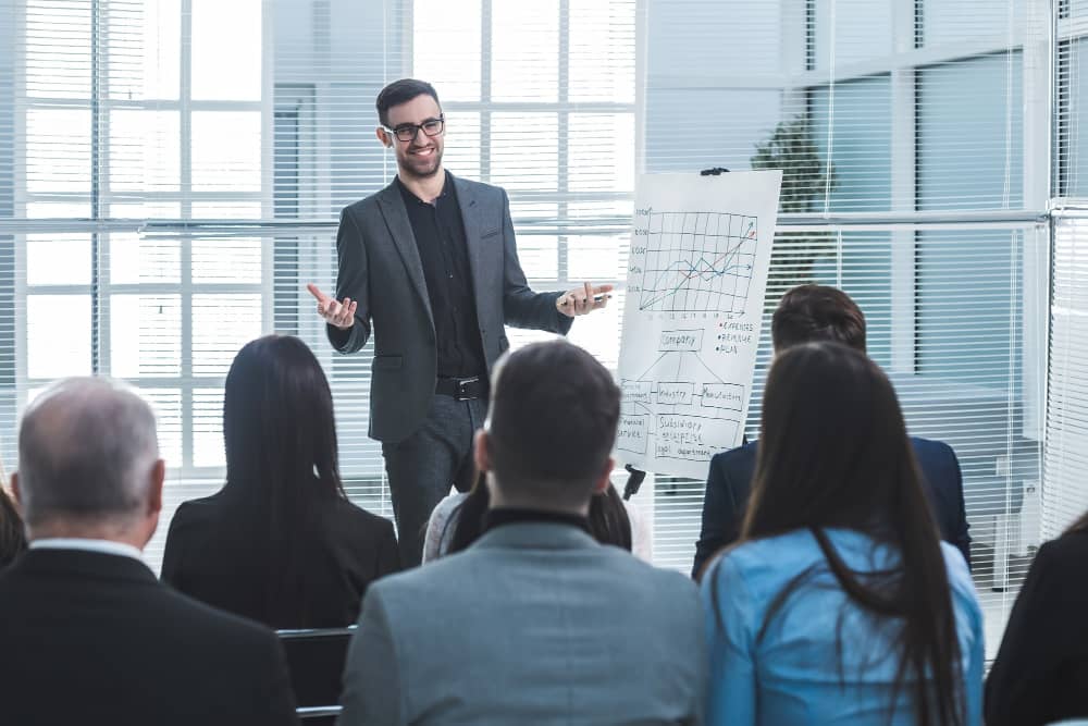 Presenter speaking to a small group in a workshop